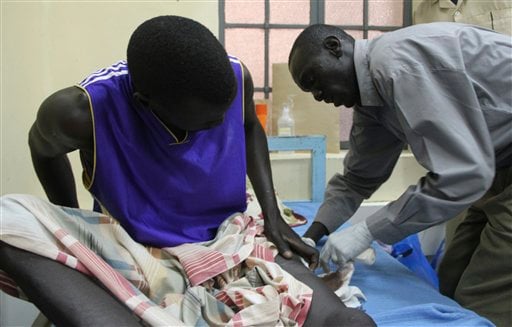 
 Puok Kai, 30, a Southern Sudanese prison officer, grimaces in pain as the dressing on his gunshot wound is changed in the Juba Teaching Hospital in the Southern Sudanese capital, Tuesday, Feb.15, 2011. Kai was wounded while defending the town of Fangak in the south's restive Jonglei state when southern rebel leader George Athor launched an attack on December 9-10. Southern leaders have accused Khartoum of backing Athor's rebellion and of supporting other militia activity in the south ahead of the oil-region's independence declaration in July. (AP Photo/Maggie Fick).
 