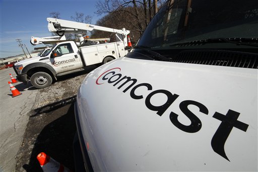 
 Comcast logos are displayed on installation trucks in Pittsburgh, Tuesday, Feb. 15, 2011. Comcast Corp., a leading cable, entertainment and communications company, announced Wednesday, Feb. 16, that the company's planned annual dividend has increased 19% to $0.45 per share. (AP Photo/Gene J. Puskar)
 