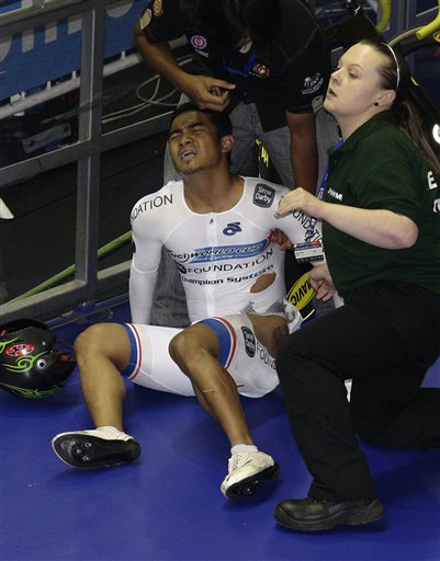 
 Malaysia's Azizulhasni Awang collapses with a splinter through his lower leg after a crash in the Men's Keirin Final during the Track Cycling World Cup at the National Cycling Centre, Manchester, England, Saturday Feb. 19, 2011. (AP Photo/Jon Super)
 