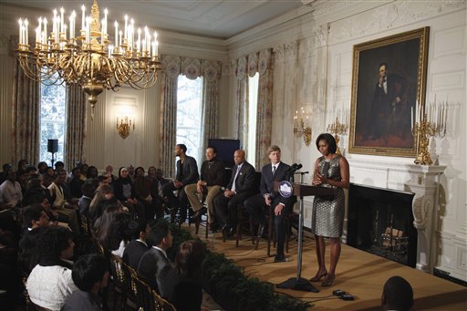 
 First lady Michelle Obama holds a music discussion for students, highlighting Motown artists, Thursday, Feb. 24, 2011, in the State Dining Room of the White House in Washington. From left are: singer John Legend; singer Smokey Robinson; Motown founder Berry Gordy Jr.; Grammy Museum Executive Director Bob Santelli, and Mrs. Obama. (AP Photo/Charles Dharapak)
 