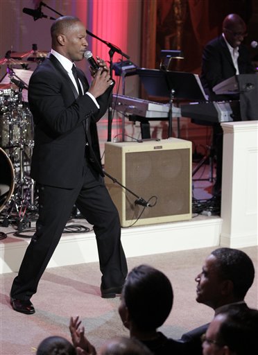 
 Singer Jamie Foxx performs on stage while President Barack Obama and first lady Michelle Obama, watch during the White House Music Series saluting Motown in the East Room of the White House in Washington, Thursday, Feb. 24, 2011. (AP Photo/Pablo Martinez Monsivais)
 