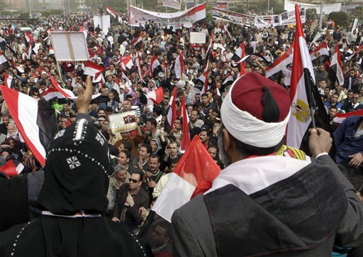
 An Egyptian Muslim Sheikh, at right, and a Coptic bishop waves Egyptian flags, as they mean a sign of solidarity, as thousands gather at Tahrir Square, the focal point of the Egyptian uprising, in Cairo, Egypt, Friday, Feb.25, 2011.The deputy to Osama bin Laden issued al-Qaida's second message since the Egyptian uprising, accusing the nation's Christian leadership of inciting interfaith tensions and denying that the terror network was behind last month's bombing of a Coptic church in Alexandria that killed 21 and sparked protests. (AP Photo/Amr Nabil)
 