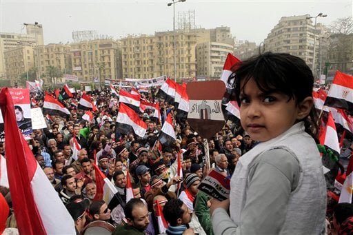 
 An Egyptian girl looks on as thousands gather at Tahrir Square, the focal point of the Egyptian uprising, in Cairo, Egypt, Friday, Feb.25, 2011. The deputy to Osama bin Laden issued al-Qaida's second message since the Egyptian uprising, accusing the nation's Christian leadership of inciting interfaith tensions and denying that the terror network was behind last month's bombing of a Coptic church in Alexandria that killed 21 and sparked protests. (AP Photo/Amr Nabil)
 