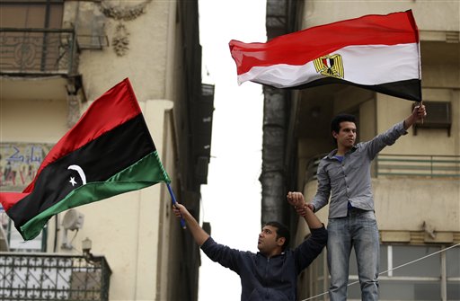 
 Egyptian protesters a wave Libya's old national flag and an Egyptian flag during the Friday demonstration in the Tahrir Square in Cairo, Egypt, Friday, Feb.25, 2011.The deputy to Osama bin Laden issued al-Qaida's second message since the Egyptian uprising, accusing the nation's Christian leadership of inciting interfaith tensions and denying that the terror network was behind last month's bombing of a Coptic church in Alexandria that killed 21 and sparked protests. (AP Photo/Khalil Hamra)
 