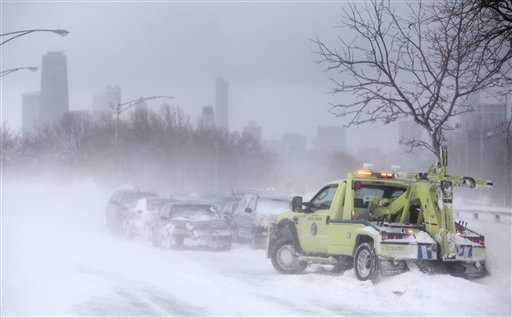 
 A tow truck is seen on Lake Shore Drive in Chicago where hundreds of cars are stranded Wednesday, Feb. 2, 2011. A winter blizzard of historic proportions wobbled an otherwise snow-tough Chicago, stranding hundreds of drivers for up to 12 hours overnight on the city's showcase lakeshore thoroughfare and giving many city schoolchildren their first ever snow day. (AP Photo/Kiichiro Sato)
 