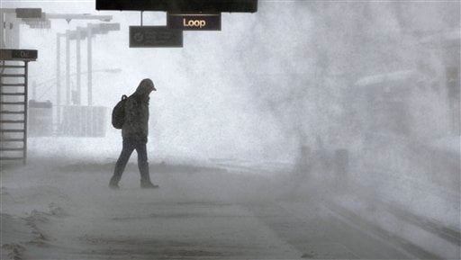
 High winds swirl the snow on an elevated train platform as Larry Roa waits for a train during a blizzard Wednesday, Feb. 2, 2011 in Chicago. Forecasts call for snow accumulation between one and two feet. (AP Photo/Charles Rex Arbogast)
 