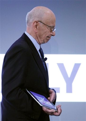 
 Rupert Murdoch, Chairman and CEO of News Corporation, holds an iPad during the launch of The Daily, Wednesday, Feb. 2, 2011 in New York. The Daily is the world's first iPad-only newspaper. (AP Photo/Mark Lennihan)
 