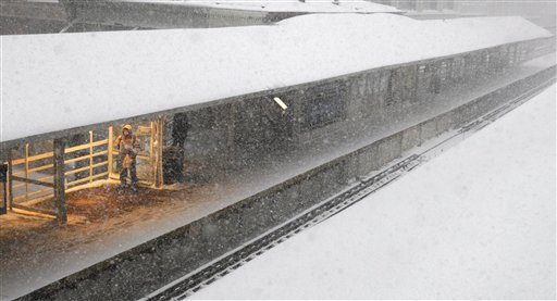 
 A commuter waits under heat lamps on an elevated train track during a blizzard Wednesday, Feb. 2, 2011 in Chicago. Forecasts call for snow accumulation between one and two feet. (AP Photo/Charles Rex Arbogast)
 