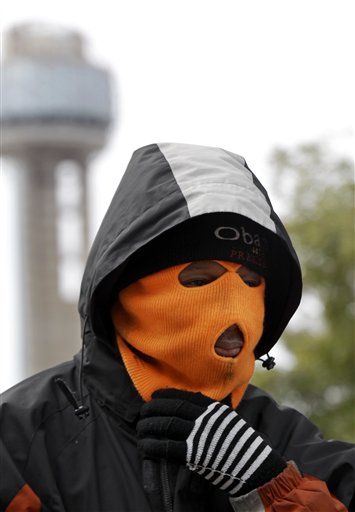 
 Lemark Davis, of Irving, Texas, adjusts his ski mask as he waits for a bus in downtown Dallas, Wednesday, Feb. 2, 2011, in Dallas. Snow and ice blanked the area on Tuesday and temperatures are forecast to remain below freezing for several days. (AP Photo/David J. Phillip)
 