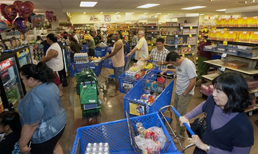 
 Hundreds of Oahu residents flocked to the Times Supermarket to purchase water and supplies Thursday, March 10, 2011 in Honolulu. The state of Hawaii is under a tsunami warning due to a large 8.9 earthquake off Japan. The earthquake is believed to have generated a tsumani wave. The Pacific Tsunami Center expects the wave to hit Hawaii at 2:59 a.m. Hawaiian Standard Time. (AP Photo/Eugene Tanner)
 