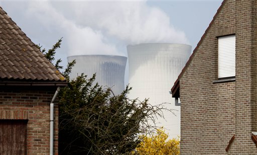 
 Two nuclear cooling towers are seen between two houses in Doel, Belgium on Tuesday, March 15, 2011. In response to events taking place in Japan, the Belgian government has opened a website with information on evacuation in the event of a nuclear accident and also said that they will make iodine tablets available to all residents in the evacuation zone. Belgium currently has two operating nuclear power plants. (AP Photo/Virginia Mayo)
 