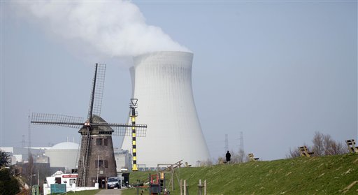 
 A nuclear cooling tower is seen next to a historical windmill in Doel, Belgium on Tuesday, March 15, 2011. In response to events taking place in Japan, the Belgian government has opened a website with information on evacuation in the event of a nuclear accident and also said that they will make iodine tablets available to all residents in the evacuation zone. Belgium currently has two operating nuclear power plants. (AP Photo/Virginia Mayo)
 