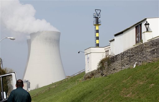 
 A man looks at a nuclear cooling tower in Doel, Belgium on Tuesday, March 15, 2011. In response to events taking place in Japan, the Belgian government has opened a website with information on evacuation in the event of a nuclear accident and also said that they will make iodine tablets available to all residents in the evacuation zone. Belgium currently has two operating nuclear power plants. (AP Photo/Virginia Mayo)
 