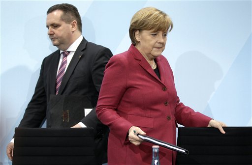 
 German Chancellor Angela Merkel, right, and the governor of the German state of Baden-Wuerttemberg, Stefan Mappus, left, arrive for a news conference in Berlin, Germany, Tuesday, March 15, 2011. Germany will take seven of its 17 nuclear reactors offline for three months while the country reconsiders plans to extend the life of its atomic power plants in the wake of events in Japan, Chancellor Angela Merkel said Tuesday. (AP Photo/Michael Sohn)
 