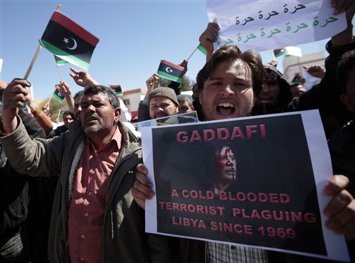 
 Libyan anti-government protesters, some carrying monarchist-era flags, chant slogans as they demonstrate against Libyan leader Moammar Gadhafi, in the southwestern town of Nalut, Libya, Tuesday, March 1, 2011. The town is currently in control of the Libyan anti-government forces. (AP Photo/Lefteris Pitarakis)
 