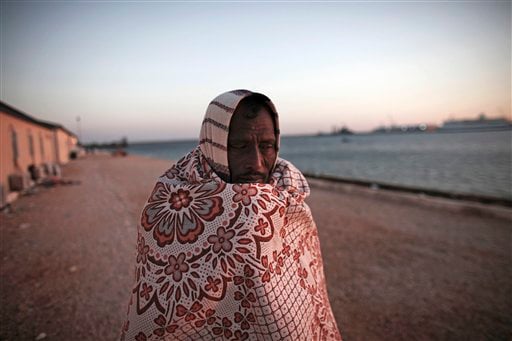 
 A Bangladeshi worker who has been trying to leave Libya for over six days, walks near the water as he waits at the port in the eastern city of Benghazi, Libya, on Tuesday, March 1, 2011. (AP Photo/Tara Todras-Whitehill)
 