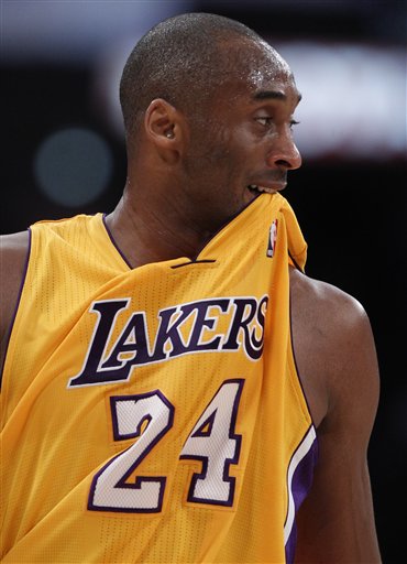 
 Los Angeles Lakers' Kobe Bryant bites his jersey during the first half of an NBA basketball game against the San Antonio Spurs in Los Angeles, Tuesday, April 12, 2011. (AP Photo/Chris Carlson)
 