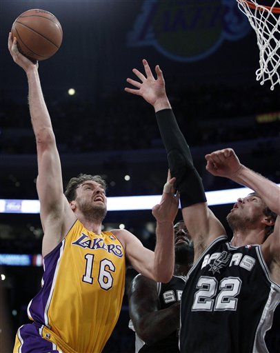 
 Los Angeles Lakers' Pau Gasol, left, shoots over San Antonio Spurs' Tiago Splitter during the first half of an NBA basketball game in Los Angeles, Tuesday, April 12, 2011. (AP Photo/Chris Carlson)
 
