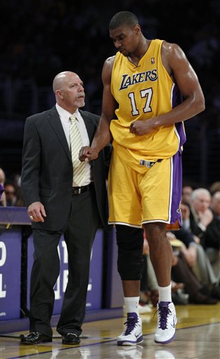 
 Los Angeles Lakers' Andrew Bynum is helped off the floor by trainer Gary Vitti after injuring his right knee during the second quarter of an NBA basketball game against the San Antonio Spurs in Los Angeles, Tuesday, April 12, 2011. (AP Photo/Chris Carlson)
 