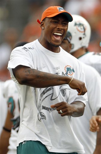 
 FILE - This Dec. 5, 2010, file photo shows Miami Dolphins wide receiver Brandon Marshall reacting on the sidelines to a penalty called against his team in the fourth quarter during an NFL football game against the Cleveland Browns, in Miami. Marshall did not play due to a hamstring injury. Marshall's wife is accused of stabbing the Miami Dolphins wide receiver and has been arrested on a domestic violence charge, according to a police report. The report, which was posted on The South Florida Sun Sentinel's website, says Michi Nogami-Marshall stabbed her husband with a kitchen knife Friday, April 22, 2011. (AP Photo/J Pat Carter, File)
 