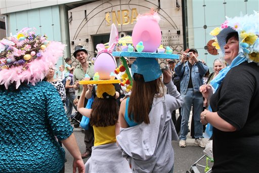 
 Leah, 11, foreground second from left, and her friend Rachel, 10, foreground second from right, both from New Jersey, pose for photographers with others wearing hats as they take part in the Easter Parade along New York's Fifth Avenue Sunday April 24, 2011. (AP Photo/Tina Fineberg)
 