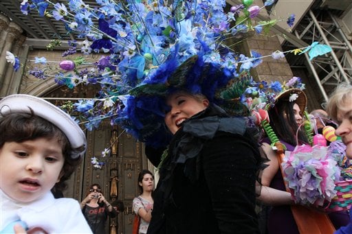 
 Vanessa Sterbenz-Guerra, of the Queens borough of New York, foreground wearing black, smiles as she poses for photographs with a flowery hat atop her head as she and others take part in the Easter Parade along New York's Fifth Avenue Sunday April 24, 2011. (AP Photo/Tina Fineberg)
 
