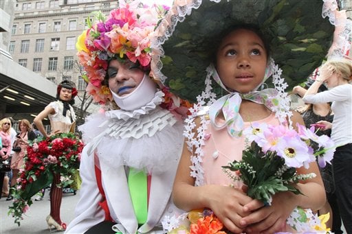 
 Dinah King, 6, of the Queens borough of New York, foreground right, and a man calling himself Muffinhead, foreground left, pose for photographers as they take part in the Easter Parade along New York's Fifth Avenue Sunday April 24, 2011. (AP Photo/Tina Fineberg)
 
