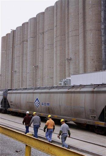
 In this photo taken July, 2009, Archer Daniels Midland Company workers walk along the grain silos next to the rail car tracks at the ADM plant in Decatur, Ill. Agribusiness conglomerate Archer Daniels Midland Co. announced plans Wednesday, Jan. 11. 2012 to cut 1,000 jobs, or about 3 percent of its total workforce, with the majority of the positions being salaried staff. (AP Photo/Seth Perlman)
 