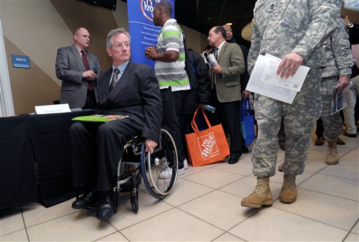 
 FILE - In this Feb. 9, 2012 file photo, disabled army veteran Ken Higgins, of Lilburn, Ga., finishes with a recruiter as he and other veterans attend a military-to-civilian job and education fair held at Turner Field, in Atlanta. General Electric Co. plans to hire 5,000 veterans over the next five years and invest $580 million to expand its aviation business. (AP Photo/John Amis, File)
 